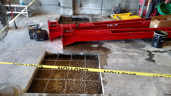 Auto lift installation in existing shop including concrete prep work.